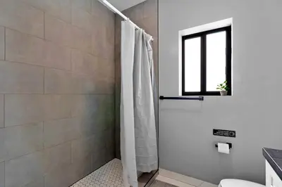 a bathroom with a shower with a shower curtain at Urban Comfort - 20min to Beach & Airport in Miami