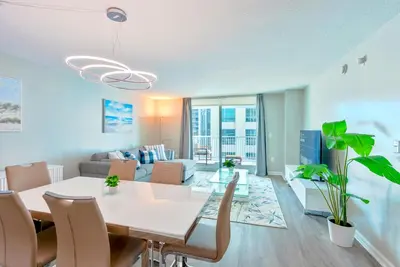 a living room with a white table and chairs at Brickell Condo w City View & Pool Access in Miami