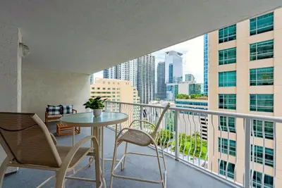 a balcony with a table and chairs and a view of the city at Brickell Condo w City View & Pool Access in Miami