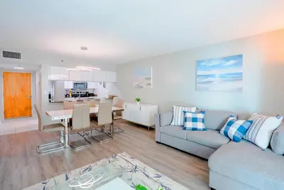 a living room and kitchen with a couch and a table at Brickell Condo w City View & Pool Access in Miami