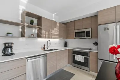 a kitchen with wooden cabinets and stainless steel appliances at Luxury Pent House with Downtown Views in Miami