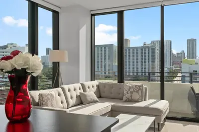 a living room with a couch and a vase with flowers at Luxury Pent House with Downtown Views in Miami