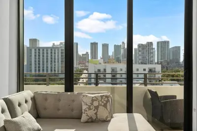 a living room with a couch and a view of a city at Luxury Pent House with Downtown Views in Miami