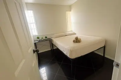 a small bedroom with a bed with a teddy bear on it at Casa Rosa Wynwood in Miami