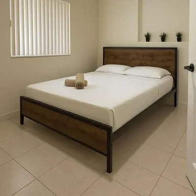 a bedroom with a large bed with a hat on it at Casa Rosa Wynwood in Miami