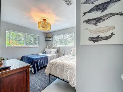 a bedroom with a bed and a desk and a window at Boho Oasis -World Cup base- under 20 min to stadium & FLL airport in Fort Lauderdale