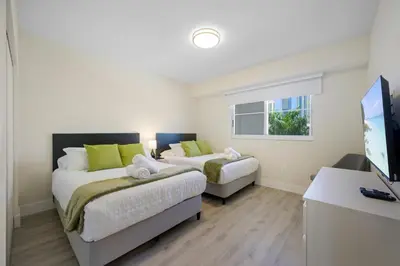a bedroom with two beds and a television in it at Golden Bay 504 in Sunny Isles Beach