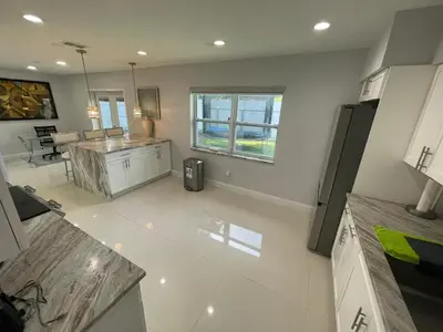 an aerial view of a kitchen and living room at Spacious 4BR Home 5 Min from Hard Rock Stadium in Miami Gardens