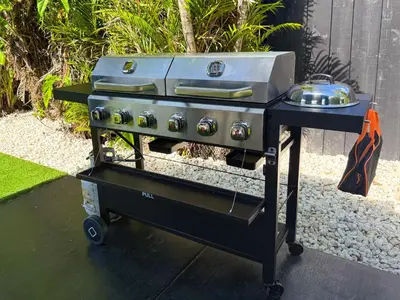 a grill on a cart with a pot on it at The LuxeLanding MIA- Swimming pool, Oasis Lounge, Mini Golf, BBQ and Hibachi Grill , and Outdoor Games in Miami