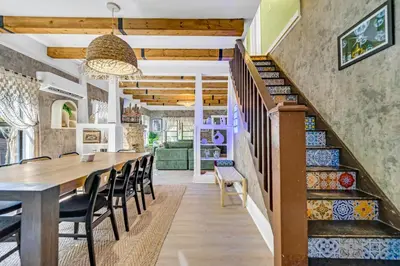 a dining room with a table and chairs and a staircase at Casa Alaïa West Brickell Sleeps 20 Pool&Spa in Miami