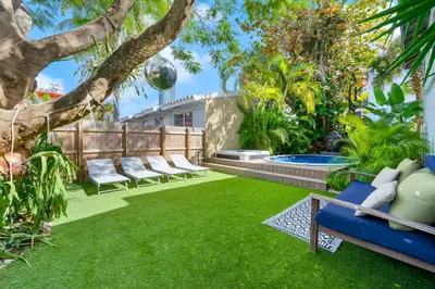 a garden with chairs and a swimming pool at Casa Alaïa West Brickell Sleeps 20 Pool&Spa in Miami