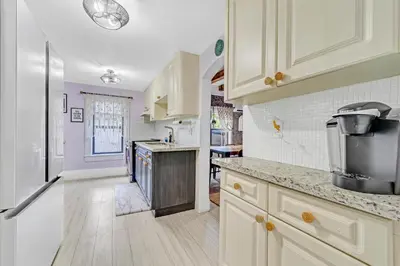a kitchen with white cabinets and a refrigerator at Casa Alaïa West Brickell Sleeps 20 Pool&Spa in Miami