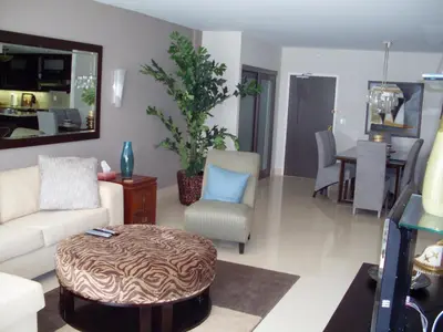 a living room with a couch and chairs and a table at 2 bedroom at The Roney Palace Condominiums Apt 1006 in Miami Beach
