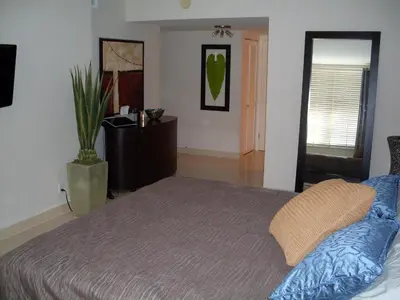 a bedroom with a bed and a potted plant at 2 bedroom at The Roney Palace Condominiums Apt 1006 in Miami Beach