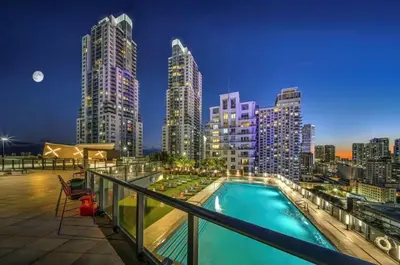 a swimming pool on the roof of a building with a city skyline at Electric Luxury Downtown Bayfront Brickell in Miami