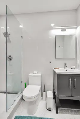 a bathroom with a toilet and a sink and a shower at Comfort and Space Fort Lauderdale Miami in Fort Lauderdale