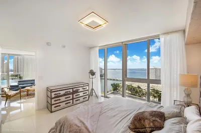 a bedroom with a bed and a view of the ocean at Sublime Ocean & Pool View Unit At Icon Brickell in Miami