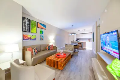 a living room with a couch and a tv at Elegant Beachfront Retreat in Hollywood