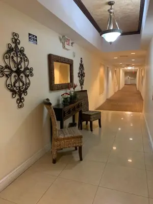 a hallway with a table and chairs and a mirror at 202 Private bedroom in Miami - Coral Gables in Miami