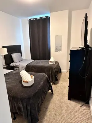 a room with two beds and a flat screen tv at 202 Private bedroom in Miami - Coral Gables in Miami