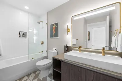 a bathroom with a sink and a toilet and a mirror at Gale Hotel - Premium Studio W Panoramic City Views in Miami