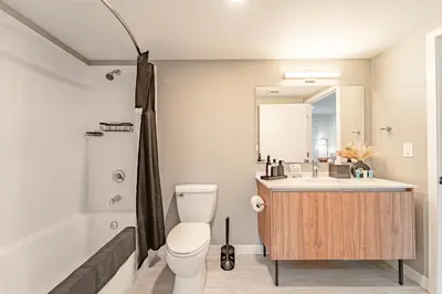 a bathroom with a sink and a toilet and a tub at Devereaux Miami Luxury 2 Bedroom Apartment in Biscayne Gardens