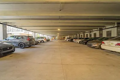 a parking garage filled with lots of parked cars at Devereaux Miami Luxury 2 Bedroom Apartment in Biscayne Gardens