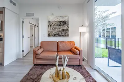 a living room with a couch and a table at Devereaux Miami Luxury 2 Bedroom Apartment in Biscayne Gardens