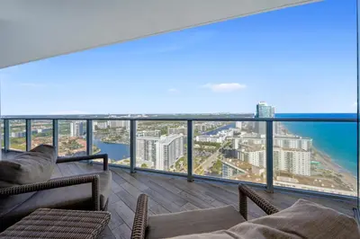 a balcony with chairs and a view of the ocean at Luxury 2BR Beachfront Rooftop Pool and Spa in Hollywood