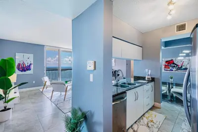 a kitchen with a sink and a dining room at Top Floor Front Facing Penthouse With Breathtaking Views in Miami