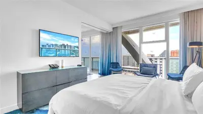 a bedroom with a large bed and a large window at Exclusive Beachfront Condo at W Fort Lauderdale in Fort Lauderdale