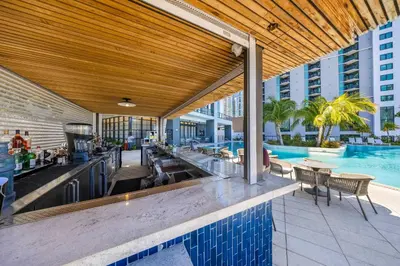 an outdoor bar with a swimming pool and a building at Stylish City Condo in the Heart of Downtown Miami in Miami
