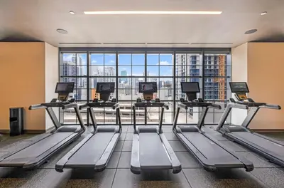 a gym with several treadmills and a large window at Stylish City Condo in the Heart of Downtown Miami in Miami