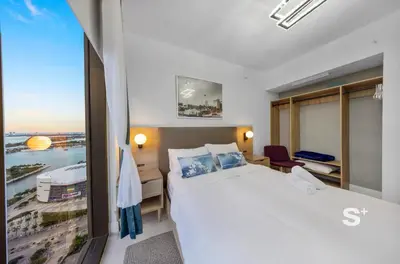 a hotel room with a large bed and a window at Stylish City Condo in the Heart of Downtown Miami in Miami