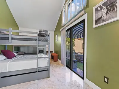 a bedroom with a bunk bed and a balcony at The Velvet Palm Midtown Pool and Hot Tub in Miami