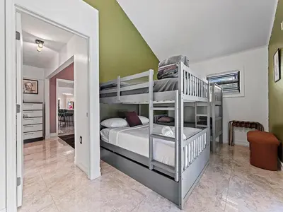a bedroom with two bunk beds and a staircase at The Velvet Palm Midtown Pool and Hot Tub in Miami