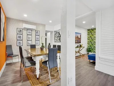 a dining room and living room with a table and chairs at Bungalow House 6 BR Pool Little Havana in Miami