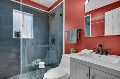 a bathroom with a shower and a toilet and a sink at La Pergola Villa 7 BR PoolHot Tub Location in Miami