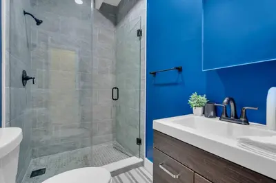 a bathroom with a shower and a toilet and a sink at La Pergola Villa 7 BR PoolHot Tub Location in Miami