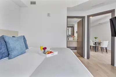 a bedroom with a white bed with a tray of fruit on it at MVR Stunning Views Superhost Service in Miami