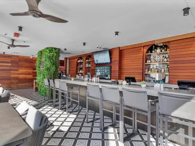 a restaurant with a bar with chairs at MVR Stunning Views Superhost Service in Miami