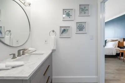 a white bathroom with a sink and a mirror at Sunset Suite Skyline Views King and Twin Sofa Includes Parking in Miami
