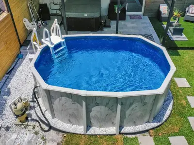 a hot tub with a chair in a yard at Canal Views from Pool w BBQ and Pit Miami Escape in Kendale Lakes