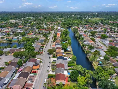 an aerial view of a town with a river at Canal Views from Pool w BBQ and Pit Miami Escape in Kendale Lakes