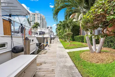 a row of boats parked in a canal with palm trees at Coconut Bay Resort in Fort Lauderdale