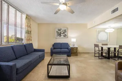 a living room with a couch and a table at Coconut Bay Resort in Fort Lauderdale