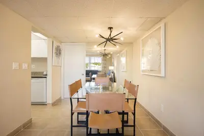 a dining room and kitchen with a table and chairs at Coconut Bay Resort in Fort Lauderdale