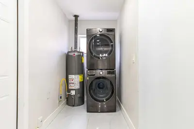 a washer and dryer in a laundry room at Stylish 3BR Home - BBQ & Near Top Attractions in Miami Gardens