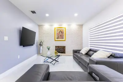 a living room with a couch and a tv at Stylish 3BR Home - BBQ & Near Top Attractions in Miami Gardens