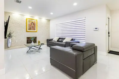 a living room with a couch and a fireplace at Stylish 3BR Home - BBQ & Near Top Attractions in Miami Gardens